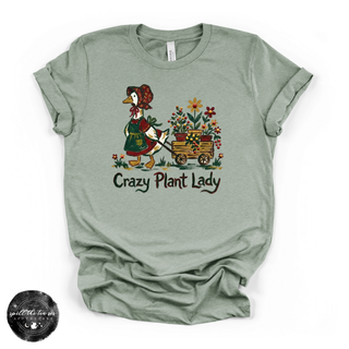Green t-shirt with a graphic of a goose and flowers and the text 'Crazy Plant Lady' on a white background.