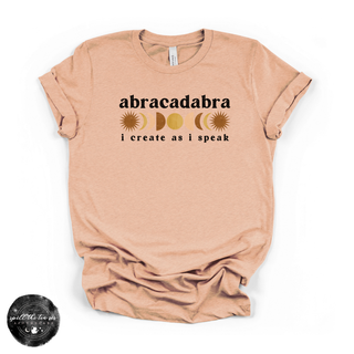 Abracadabra I create as I speak graphic tee peach