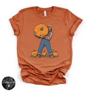 Bigfoot Carrying Pumpkin Tee | Funny Sasquatch Fall Graphic T-Shirt