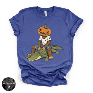 Pumpkin Head Bigfoot on a Crocodile Tee | Funny Cryptid Halloween Graphic T-Shirt